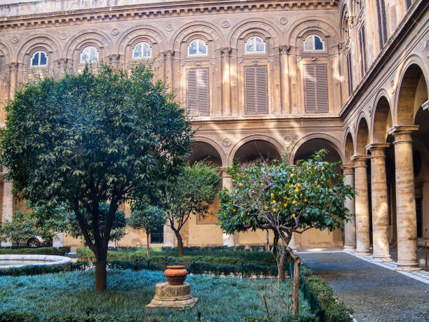 Courtyard  Palazzo Doria Pamphilj in Rome ROME, ITALY - FEBRUARY 24, 2012: Courtyard of Palazzo Doria Pamphili on Via del Corso with fruitful trees. Entrance is public fountain courtyard villa italian culture stock pictures, royalty-free photos & images