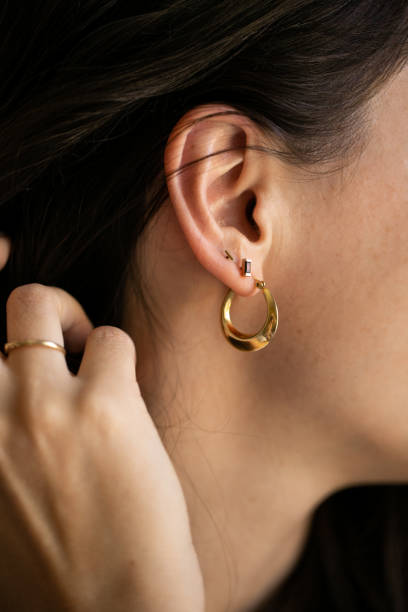istock Woman wearing gold earring 1372166579