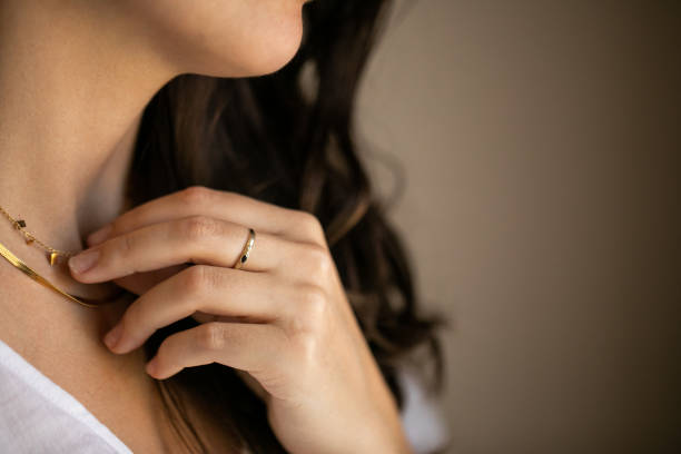 istock woman with ring holding necklace 1372167284