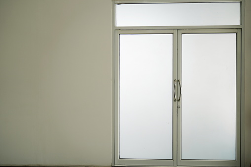 3d illustration. Modern sliding glass door in the office. Loft style interior