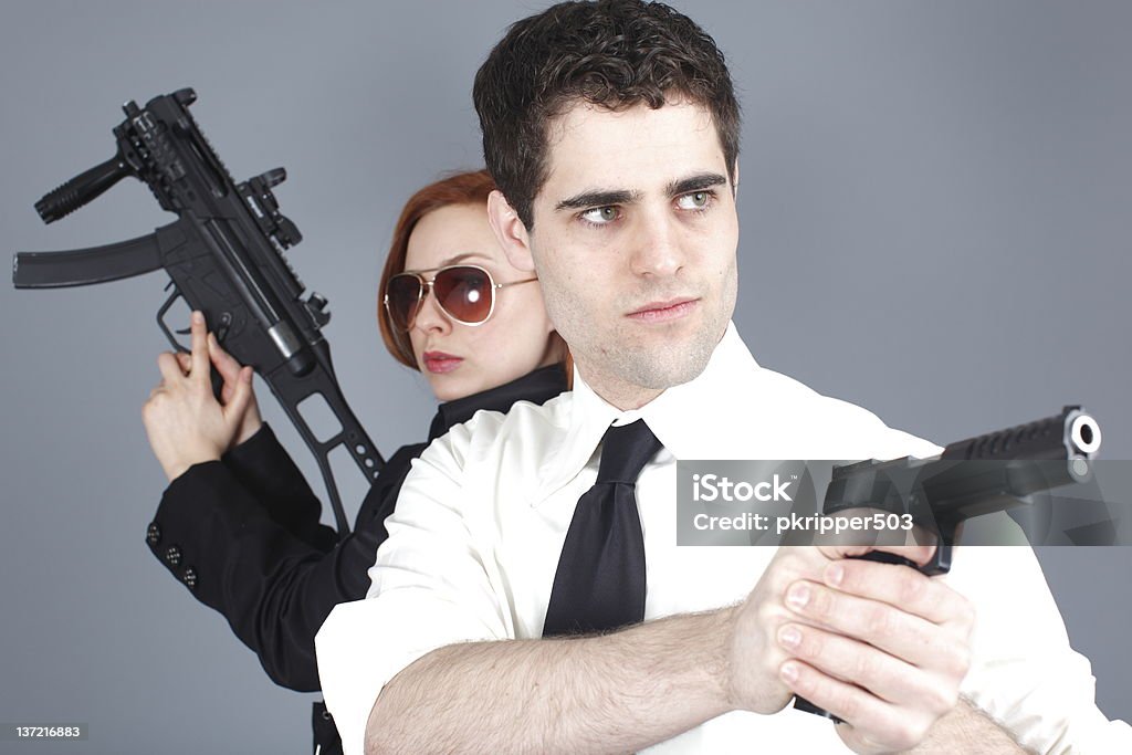Armed couple An attractive young couple with guns. 20-29 Years Stock Photo