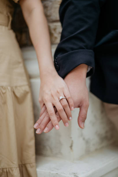 istock Asian couple hands with wedding rings 1372170030
