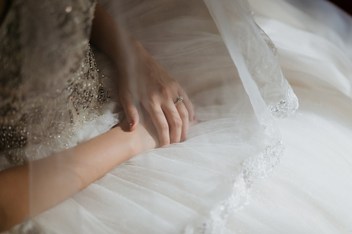 Hand of an Asian Chinese bride in wedding dress