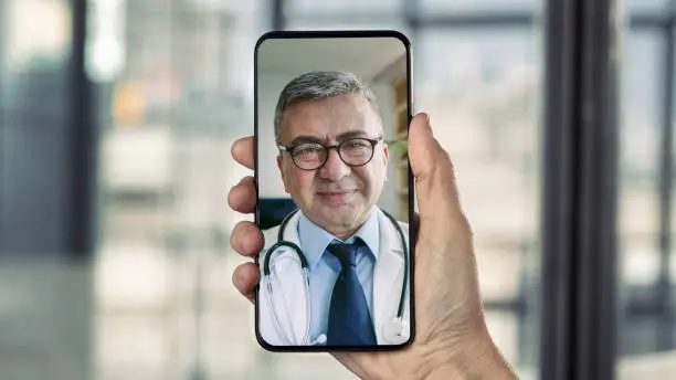 Photo of Doctor talking on mobile phone