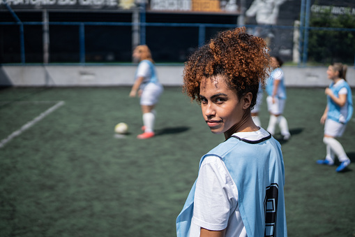 Portrait of a young female soccer player in a sports court