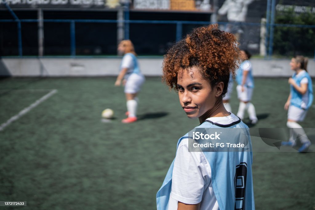 Portrait of a young female soccer player in a sports court Soccer Stock Photo