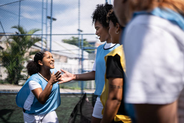 istock Female soccer players shaking hands before the match 1372172436