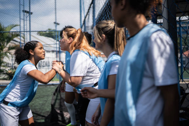 istock Female soccer players shaking hands before the match 1372172444