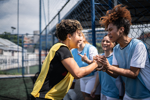 Female soccer players shaking hands before the match