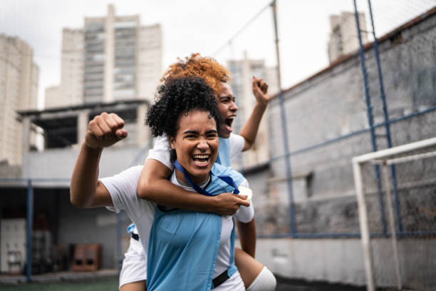 Female soccer players celebrating a goal Female soccer players celebrating a goal offense sporting position photos stock pictures, royalty-free photos & images