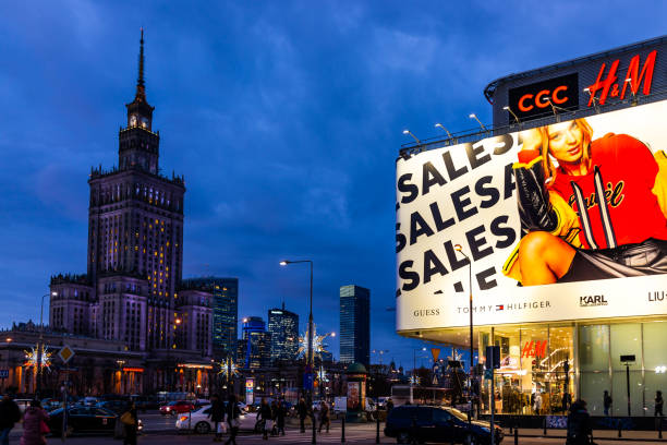 Warszawa Tower palace of science and culture buildings at night and advertisement billboard sign for shopping stock photo