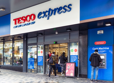 Glasgow, Scotland - People near the entrance of a Tesco express store on Sauchiehall Street in Glasgow's city centre.