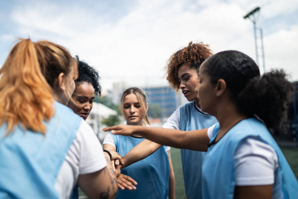 istock Female soccer team huddling and celebrating before training or match 1372175096