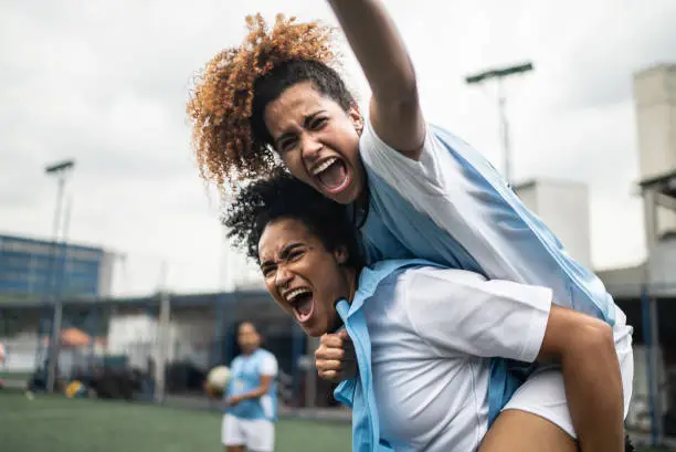 Female soccer players celebrating a goal