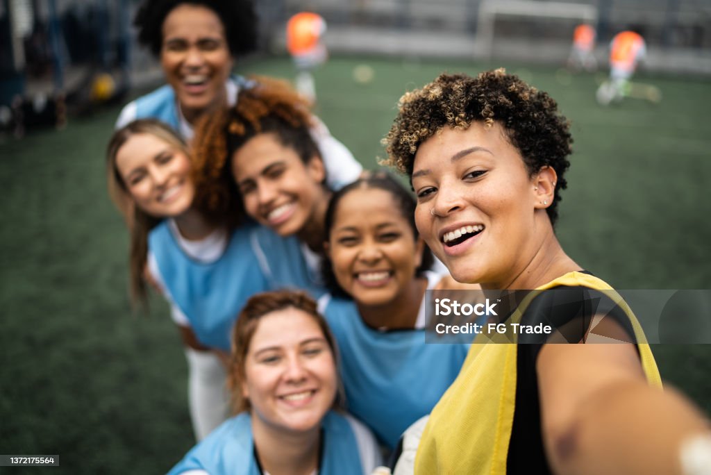 Female soccer players filming or taking selfies - camera point of view Athlete Stock Photo