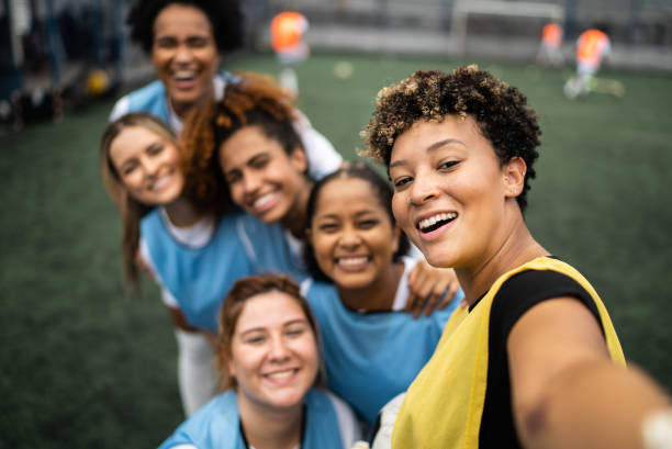 female soccer players filming or taking selfies - camera point of view - filming point of view fotos imagens e fotografias de stock