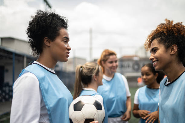 istock Female soccer players talking 1372175580
