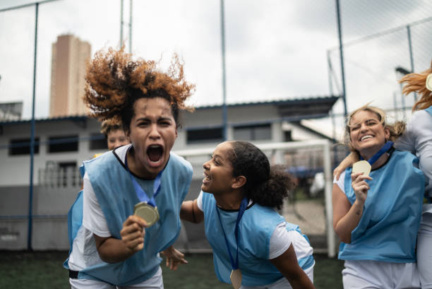 istock Female soccer players celebrating winning a medal 1372175607