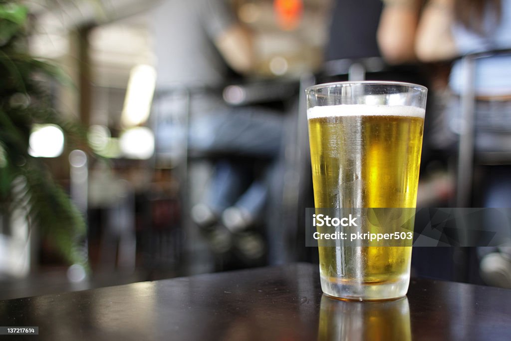 Glass of beer Glass of beer at a bar. Alcohol - Drink Stock Photo