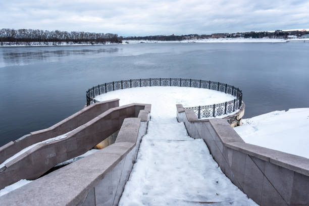 istock Granite stairs and terrace over the river under snow in winter. 1372176521