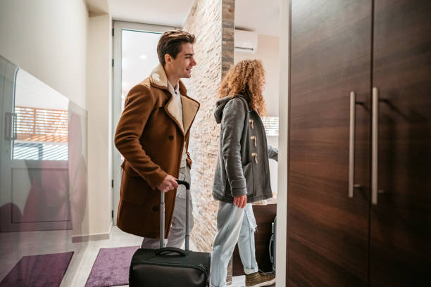 istock Young Couple Entering A Hotel Room 1372176911