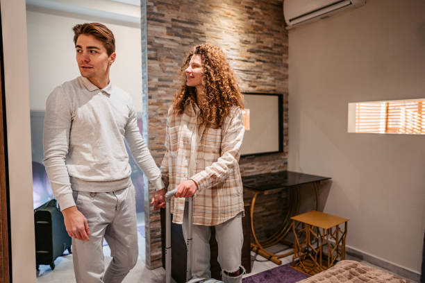 istock Young Couple Entering A Hotel Room 1372176944