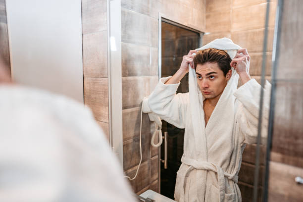 istock Young Man Looking At Himself In The Bathroom Mirror 1372177927