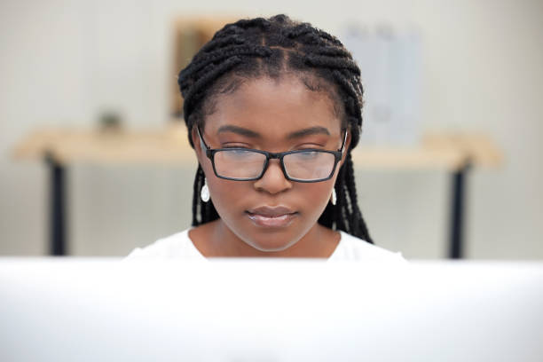istock Cropped shot of a young businesswoman using a computer while sitting at her desk 1372178764