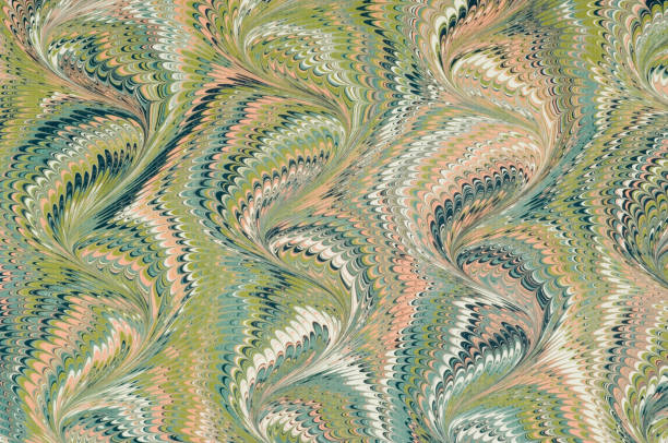 A marbled paper with visible curve pattern A sheet of marbled paper in green and pink colour. marbled effect stock pictures, royalty-free photos & images