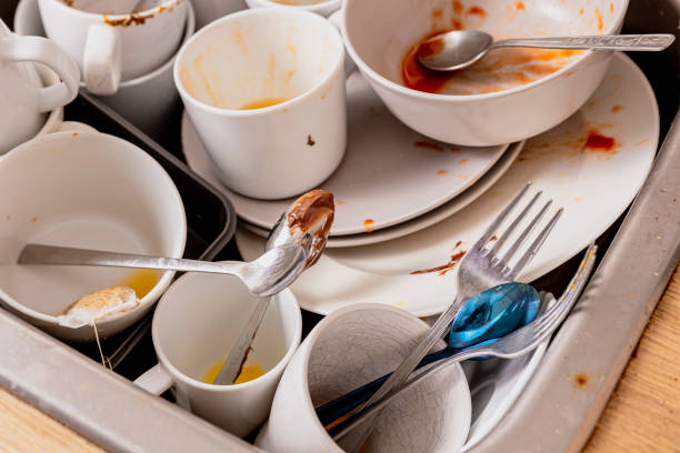 pile of unwashed, dirty dishes in the sink. mess in the kitchen. dirty kitchenware, plates and mugs. chaos at home. laziness. cluttered apartment. messy cutlery and dishware. - sink domestic kitchen kitchen sink faucet imagens e fotografias de stock