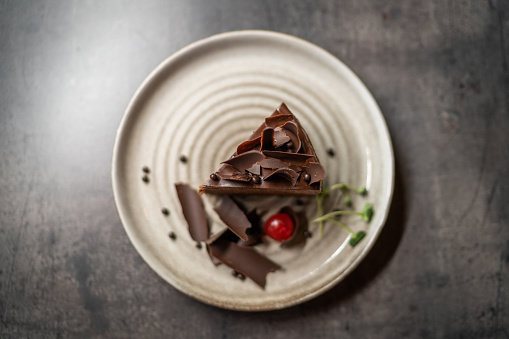 Beautiful slice of a chocolate cake on a plate.