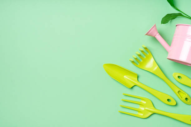 istock Growth and gardening creative concept with colors tools on green background, 1372184394