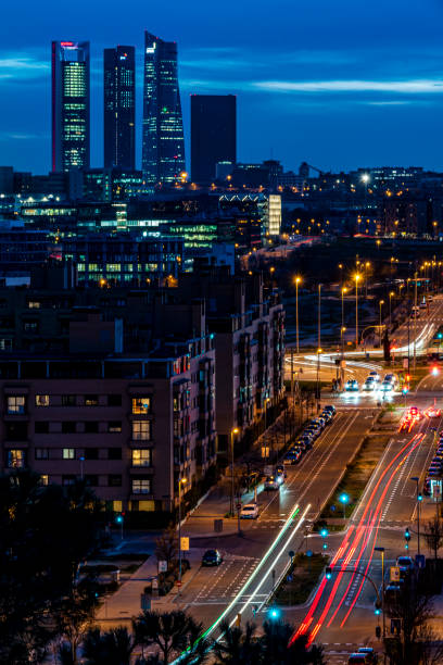 Night photography of Madrid skyline and towers and building and streets with light of cars