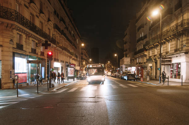istock Avenue in Paris at night with city bus 1372184524