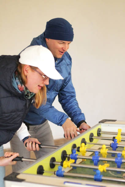 istock husband and wife are playing table soccer 1372184612