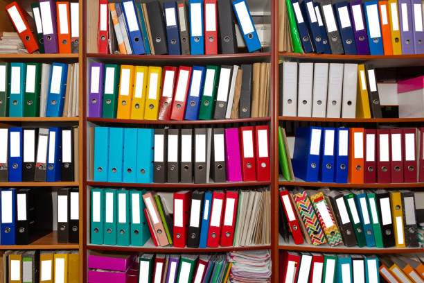 istock Colorful ring binder folder on wooden shelves, office stationary. 1372185907