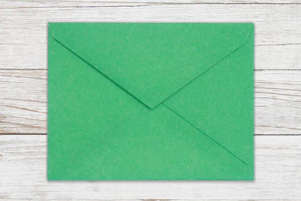 istock Green back of an envelope on weathered whitewashed wood 1372186169