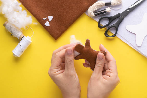 istock Filling the felt Christmas gingerbread man with holofiber. Step-by-step manufacturing instructions. Step 6. 1372187037