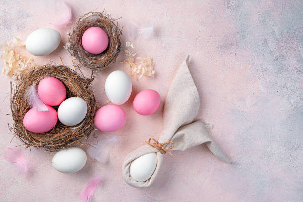 istock Happy Easter, a pastel festive background with pink and white eggs and an Easter bunny from a napkin 1372187442