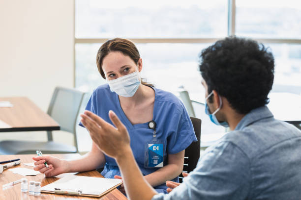 istock Nurse listens to patient 1372188456