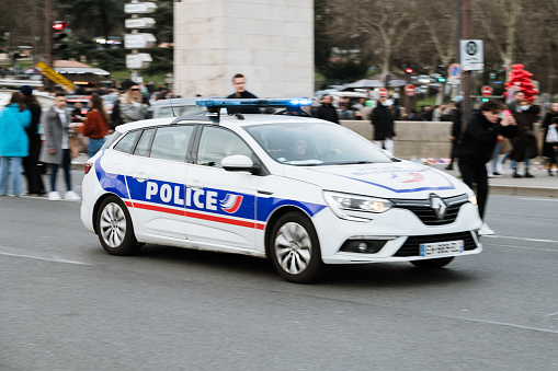 Paris, France - 13 February 2022: A Renault Megane used as a french Police car in motion in Paris, France