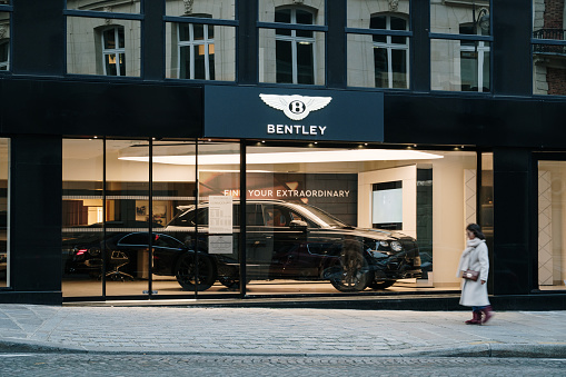 Paris, France - 13 February 2022: Exterior of a Bentley luxury vehicles store in Paris, France, with a Bentley Bentayga SUV car inside