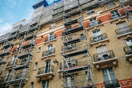 Apartment building facade with scaffolding in Paris, France