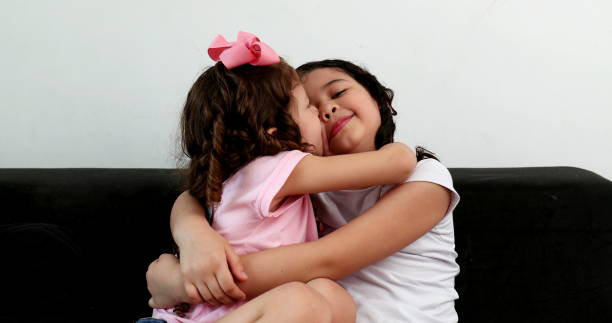 istock Children hugging each other, two little sisters hug in affection and love 1372189398