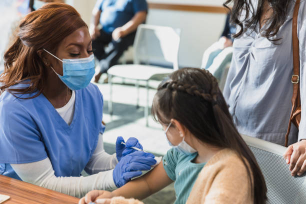 istock Nurse injects young patient 1372189819