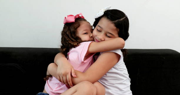 istock Children hugging each other, two little sisters hug in affection and love 1372191337