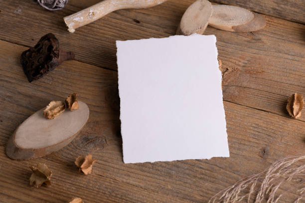istock Vertical card mockup with torn edges for wedding mockup invitation on a wooden rustic background with boho decoration 1372193387