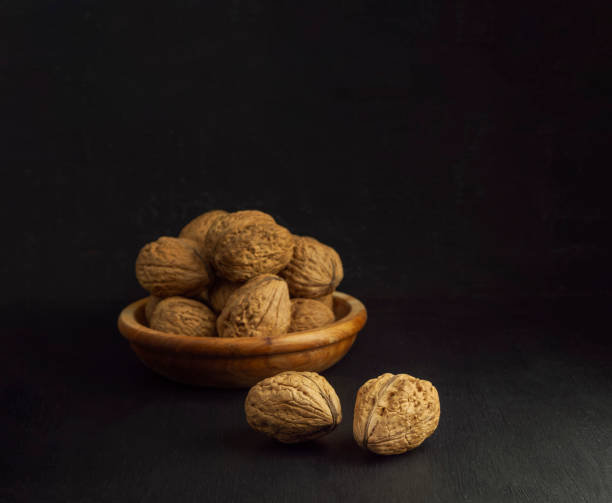 istock whole walnuts. Walnuts. Nuts. Closeup.Nuts in a wooden bowl. Useful product. Vitamins. Diet. 1372194824