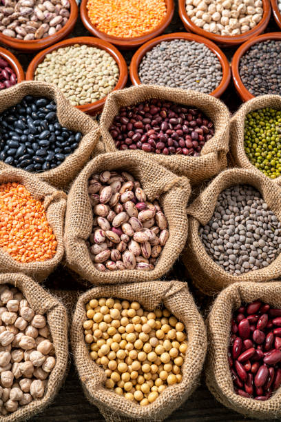 istock Assorted legumes in burlap sacks in a row as a full frame background 1372194976