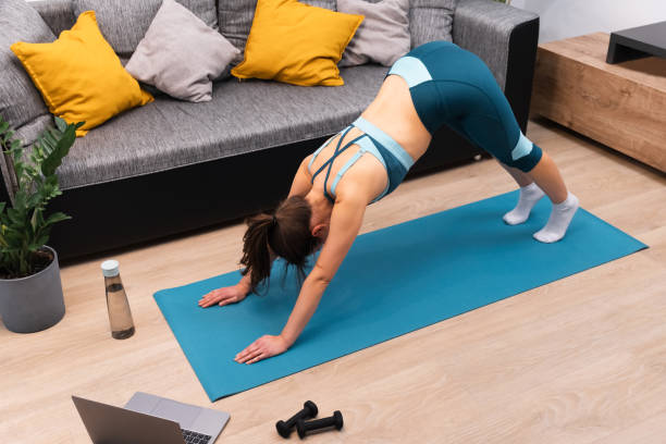 istock Touching girl is doing a stretching exercise on a gymnastic mat at home. 1372196229